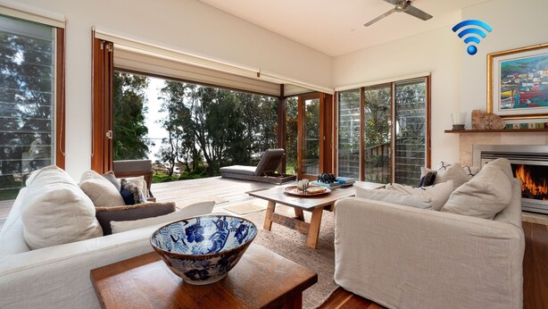 A modern living room with a sofa, a coffee table, and a fireplace. - Tula - waterfront reserve (Currarong)