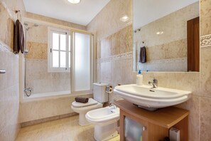 Bathtub, hair dryer, towels