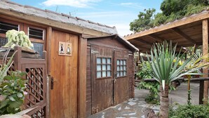 A rustic wooden building with a tiled roof, a wooden door, and a window. - Vacation Home "Casa Candelaria" with Views of El Teide, Private Pool & Wi-Fi (Arico)