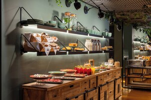 A buffet setup with various food items and beverages.