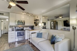 Enjoy cooking and dining in this well-equipped kitchen with appliances and a dining area.