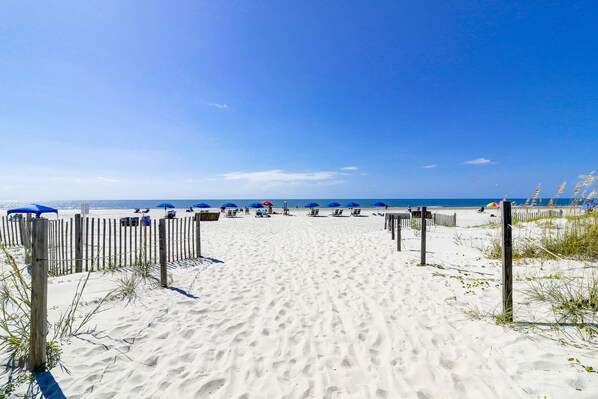 Relax on the beach with sun loungers and chairs, surrounded by scenic ocean views.