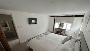 A bedroom with a bed, a desk, and a chair. - 2 Bed Grade 2 - Dates Back to 1500's (Colchester)