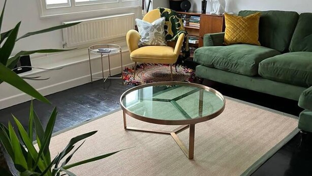 A living room with a green sofa, a yellow armchair, a glass coffee table, and a potted plant. - 2 Bed Grade 2 - Dates Back to 1500's (Colchester)