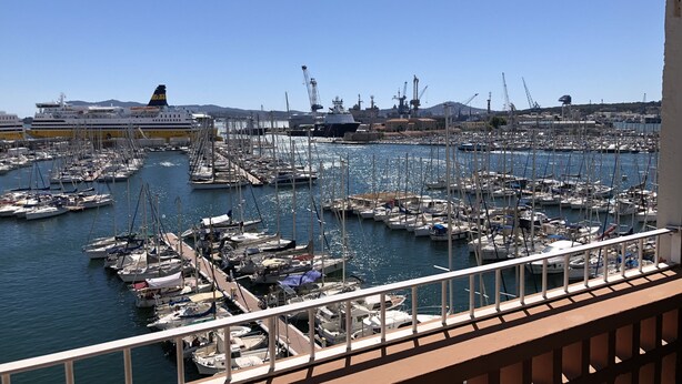 A marina with numerous boats docked, a large cruise ship in the background, and industrial buildings. - RIOPASSIONS, LARGE T3, BEAUTIFUL SEA VIEW (Toulon)