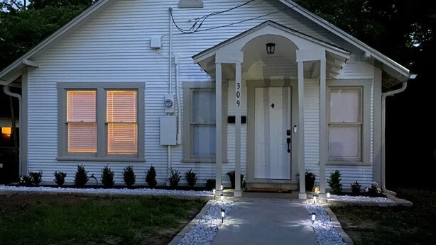 A single-story house with a front porch, a number '309' on the door, and a pathway leading to the entrance. - Tyler's Texas Rose, a beautiful 2BR/1BA house with back yard (Tyler)