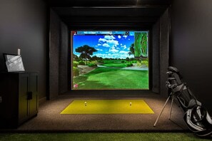 Experience golf in the comfort of your room with a virtual golf course on the large screen and a putting area.