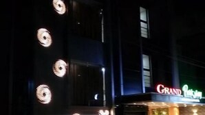A building with a sign reading "ROOMS" and another sign for "Grand Plaza." - HOTEL GRAND PARKWAY (Chennai)
