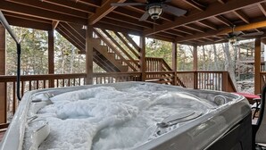 A hot tub under a wooden deck with a staircase leading to an upper level. - LAKE ARCADE - 5bd 4bth, FAMILY FUN SPOT, 3 stories (Garfield)