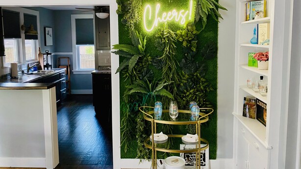A modern kitchen with a green wall, a neon sign, and a gold serving cart. - Walk to St Charles Main St. Shops, Eateries & Bars! (Saint Charles)