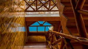 A wooden staircase with a wooden railing leading to a balcony. - Hostal Poseidon (Puerto Cayo)