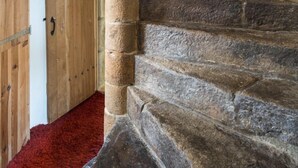 Una escalera de piedra que lleva a una puerta de madera.