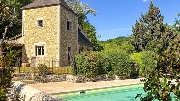 A stone building with a tower, surrounded by greenery and a swimming pool. - Les Cypres - Three Bedroom Villa, Sleeps 6 (Vézac)