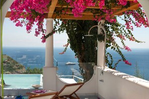 An infinity pool, sun loungers