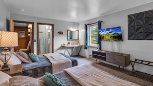 A bedroom with two beds, a desk, a dresser, and a TV. - Timberline Lodge (Ellicottville)