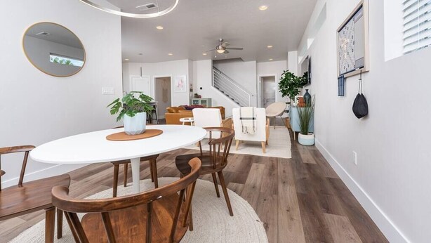 A modern dining area with a round table, wooden chairs, and potted plants. - Fun & Good Vibes in Meridian (Meridian)