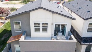 A modern two-story house with a garage, a covered patio, and a small outdoor seating area. - Fun & Good Vibes in Meridian (Meridian)