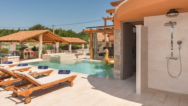 A pool area with lounge chairs, a covered seating area, and a shower. - Villa Klementina - Three Bedroom Villa, Sleeps 6 (Bicine)