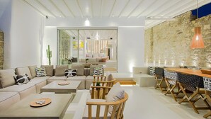 A modern living room with a sofa set, coffee table, and dining area.