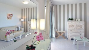 A modern bathroom with a large mirror, striped wall, and a vanity with drawers. - Villa Ipsos - Five Bedroom Villa, Sleeps 9 (Spartilas)