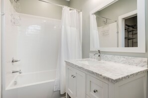 Combined shower/tub, hair dryer, towels, toilet paper - King Suite, Modern Loft Close to Downtown! (Greenville)