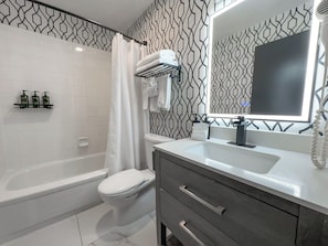 Deluxe Room, 2 Queen Beds | Bathroom | Designer toiletries, hair dryer, towels, soap