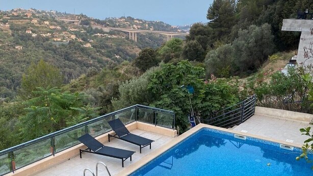 A rooftop pool with lounge chairs and a glass table, overlooking a hilly landscape with a bridge in the distance. - Spacious villa with pool in Nice (Nice)