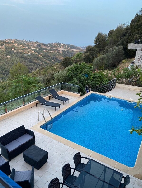 Relax by the pool with a breathtaking view of the surrounding landscape.