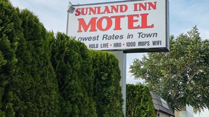 A motel sign advertising "Sunland Inn Motel" with amenities like Hulu Live, HBO, and 1000 Mbps WiFi. - Sunland Inn Motel (Ephrata)