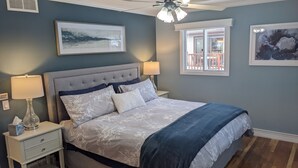 A bedroom with a bed, nightstands, a ceiling fan, and artwork on the walls. - Elegant Space–Premium Kitchen–Spacious & Ideal for Gathering w/ Friends & Family (Middleton)