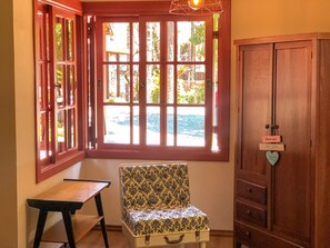 Suite | Living area | 32-inch TV with cable channels, books - Pousada Vila 505 (Canela)