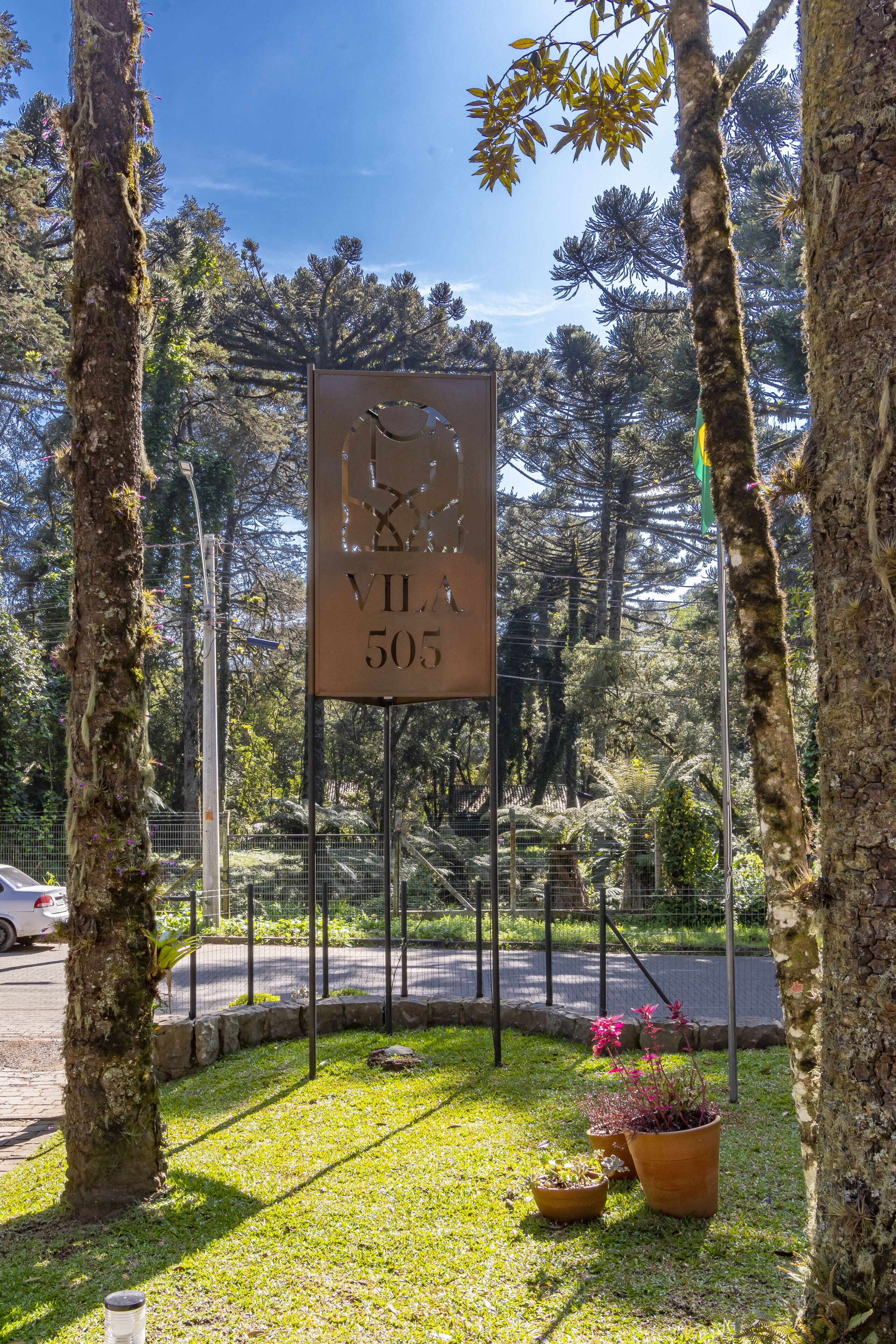 A sign with the number 505 in a natural setting with trees and grass.