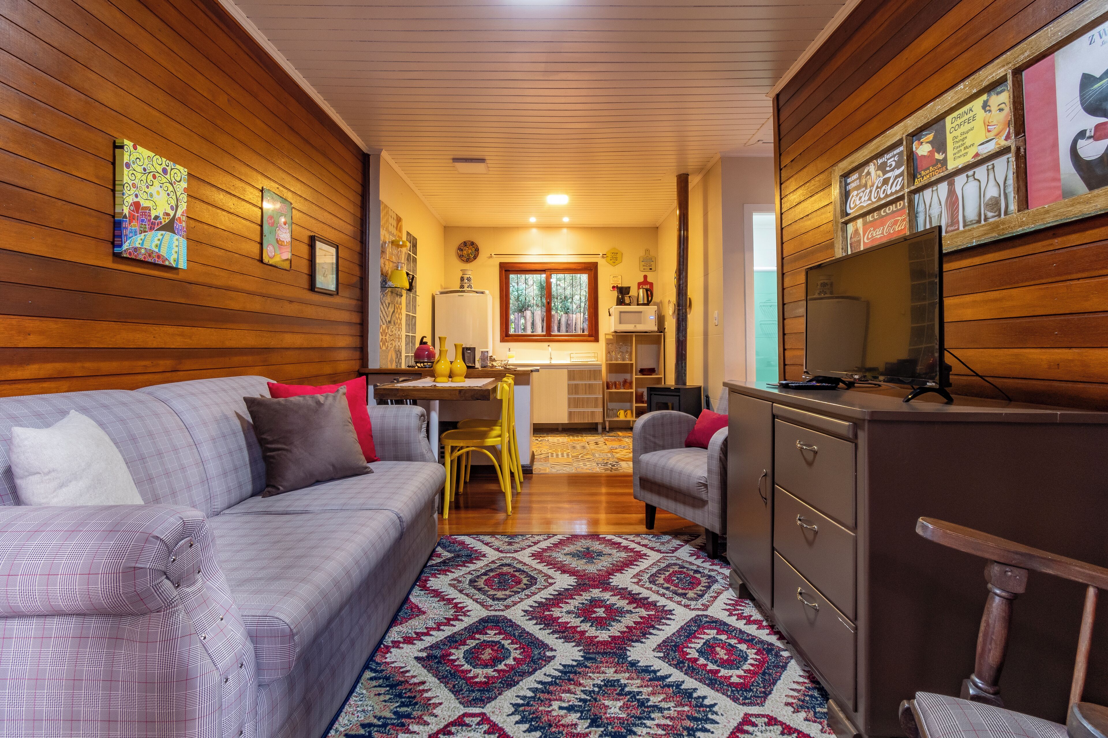 A cozy living room with a couch, a coffee table, and a patterned rug.