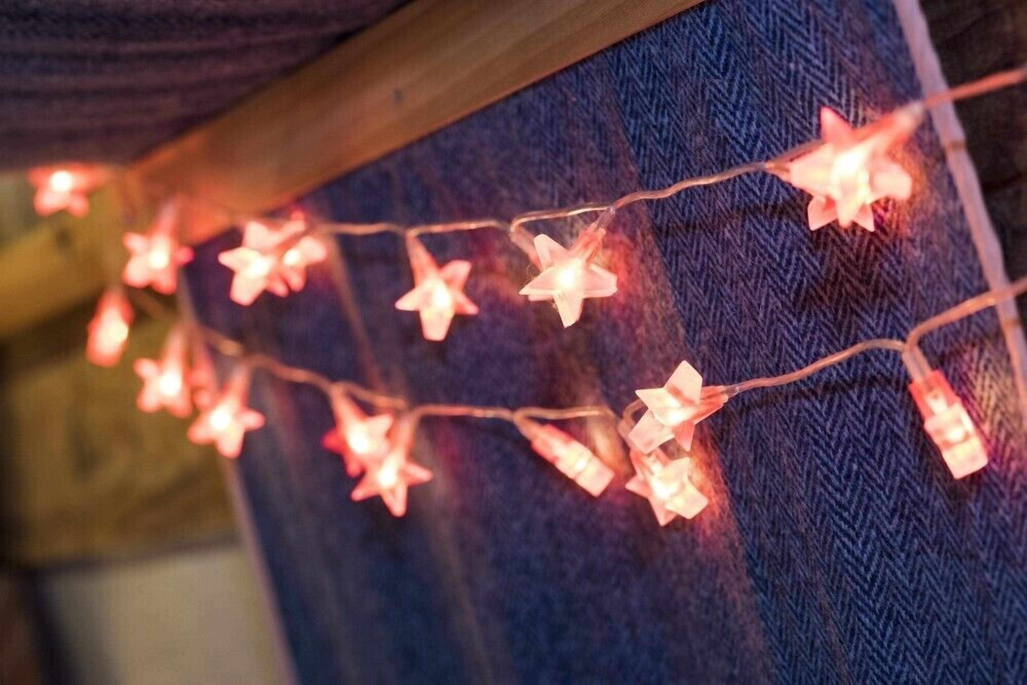 Una serie de luces en forma de estrella sobre un fondo de tela con textura.