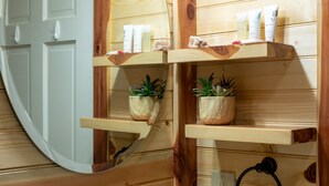 A wooden interior with a mirror, wooden shelves with toiletries, and potted plants. - Escape to cozy 2-bedroom cabin near Ouachita Forest 4 min drive away (Mena)