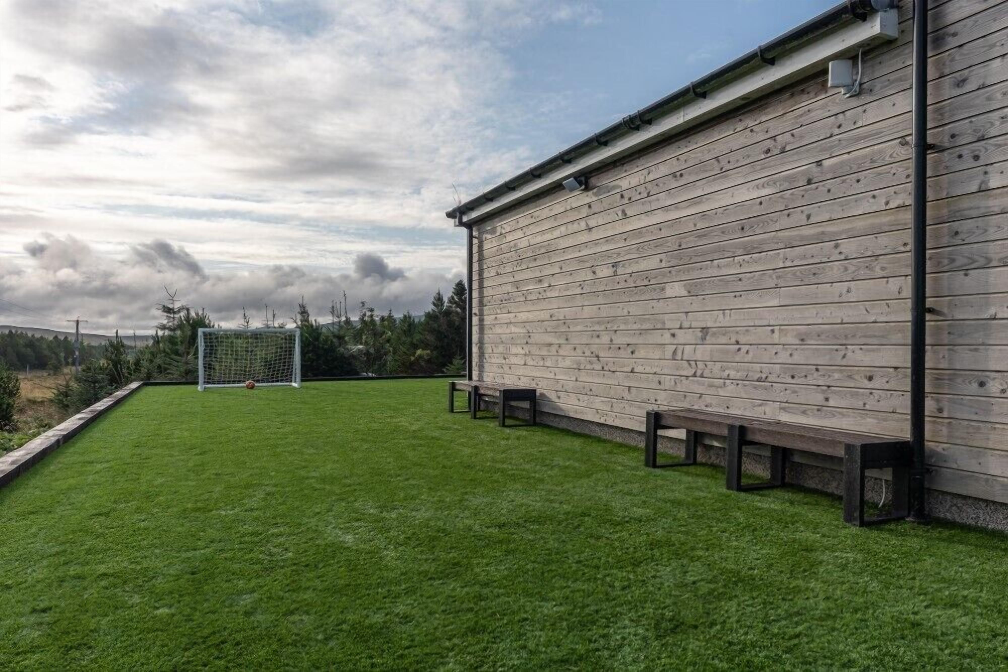 Een gebouw met een houten gevel en een gazon ervoor.