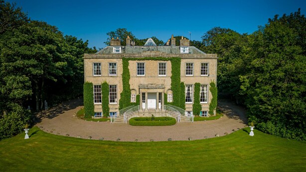 A large, historic building with a symmetrical facade, a central entrance with columns, and a formal driveway leading to the entrance. - Cortes House (Fraserburgh)