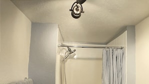 A small bathroom with a shower, toilet, and a towel rack. - Private 1br near downtown Flagstaff, NAU, Hospital (Flagstaff)