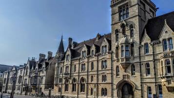 A historic building with multiple gabled roofs and arched windows, likely a hotel or public building.