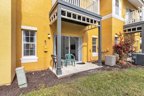 Enjoy the view from this balcony with a sliding glass door leading to a cozy indoor space.