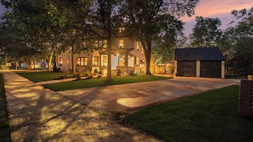 A residential property with a well-maintained lawn, a driveway, and a garage.