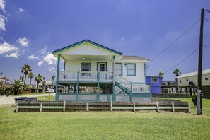 Stunning two-story home with a spacious balcony and charming porch area.