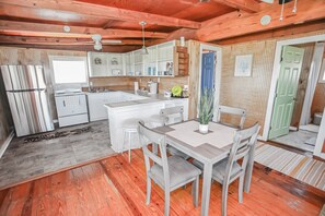 Enjoy a functional kitchen with a central island, oven, and stainless steel refrigerator.