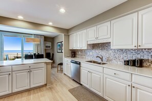 Enjoy cooking in this well-lit kitchen with a large island and dishwasher.