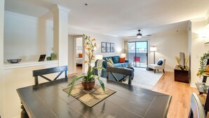 A dining area with a dark wooden table, a potted plant, and a woven placemat. - Walkable Location: Phoenix Apt w/ Pool Access! (Phoenix)