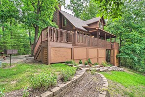 Escape to a serene forest retreat with a charming cabin featuring a spacious balcony and scenic views.