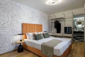 Relax in a serene bedroom with a large bed, side table, and wardrobe.