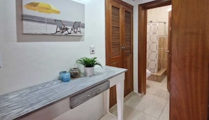 A bathroom with a shower, a towel rack, and a toilet. - Lovely Spacious Condo with Pool View, Close to Beaches and Shops! (Punta Cana)