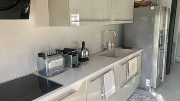 Een koelkast, een oven, een kookplaat, een vaatwasser