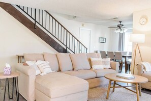 A living room with a beige sectional sofa, a coffee table, and a staircase. - 3 BD / Family Friendly / Great Location (Torrance)